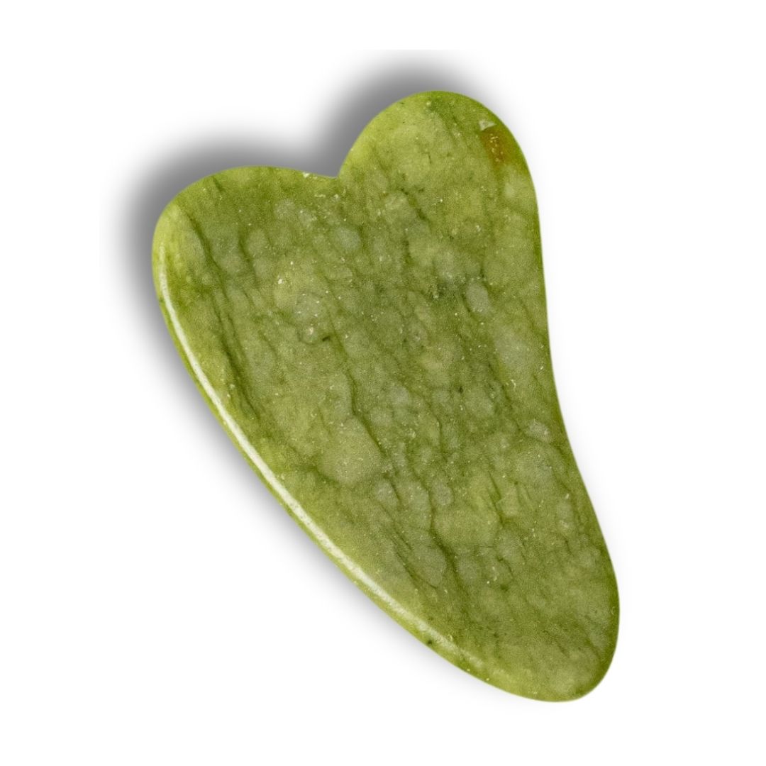 Gua Sha i grön jade från Me Anima – ett klassiskt hjärtformat verktyg som används för ansiktsmassage, lymfdränage och spänninglösning för att främja hudens elasticitet och naturliga lyster.